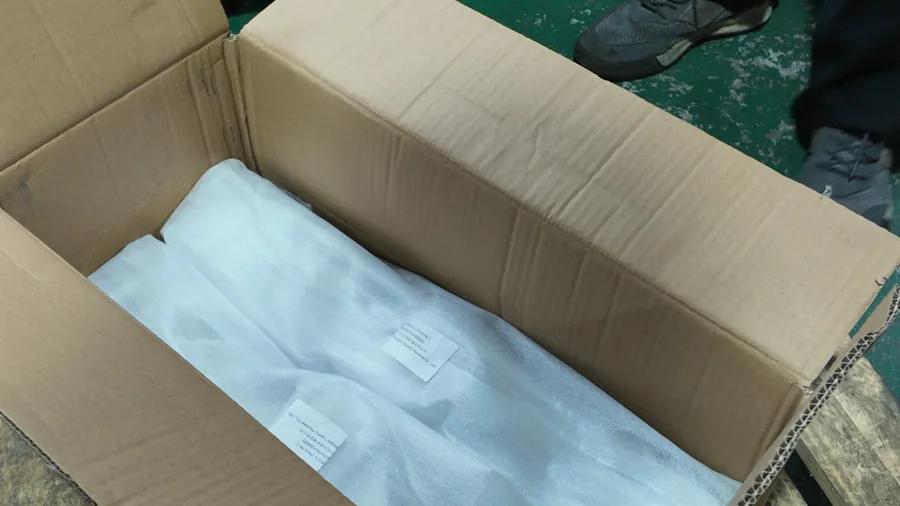 Protective white wrapping inside a carton for the support-frame batch