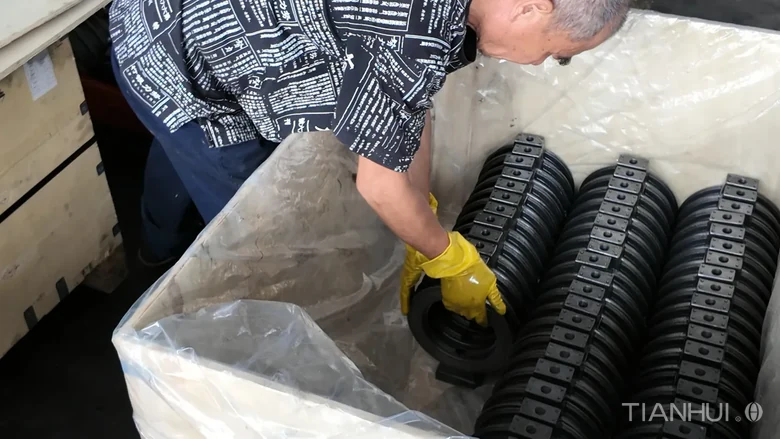 Log 16: 1,000 6-Inch Stepped Butterfly Valve Bodies for Brazil(Image5) Worker handling a stepped butterfly valve body inside a lined container